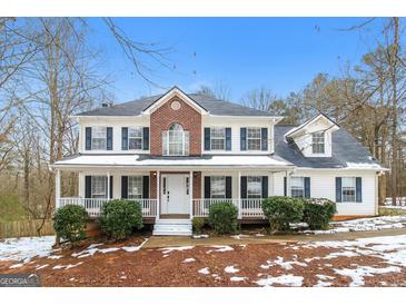 Two-story house with brick and white siding, porch, and landscaping at 380 River Point Dr, Mcdonough, GA 30252