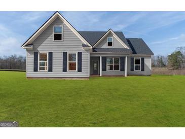 Charming gray two-story home with well-maintained lawn and traditional design elements at 123 Oak Road, Locust Grove, GA 30248