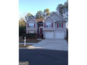 Two-story house with attached double garage and red accents at 3590 Stephens Creek Pl, Loganville, GA 30052