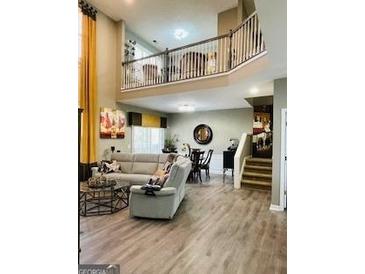 Bright living room with high ceilings and an open floor plan that leads to the dining area at 144 Cottsford Sw Dr # 22, South Fulton, GA 30331