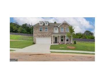 Charming two-story brick home with well-manicured lawn and inviting covered porch at 376 Collier Mills Road, Lawrenceville, GA 30045