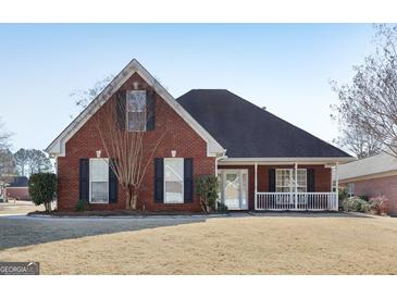 Brick house with a front porch and landscaped yard at 3013 Camille Ln, Mcdonough, GA 30253