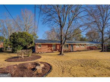 Brick ranch house with landscaped yard at 5117 Indie Se Cir, Covington, GA 30014