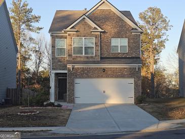 Two-story brick home with a two-car garage and landscaping at 623 Wayland Ct, Fairburn, GA 30213