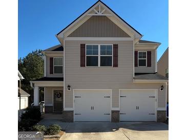 Charming two-story home with a two-car garage and neutral colored siding and brick at 151 Brasch Park Dr, Grantville, GA 30220