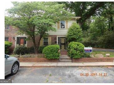 Brick house with a two-car garage and well-maintained landscaping at 123 Glen Acres Ct, Decatur, GA 30035