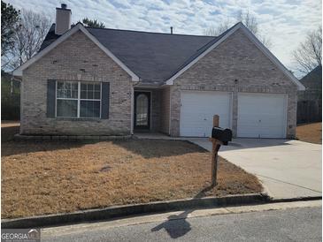 Brick house with two-car garage and mailbox at 1354 Persimmon Ct, Lithonia, GA 30058