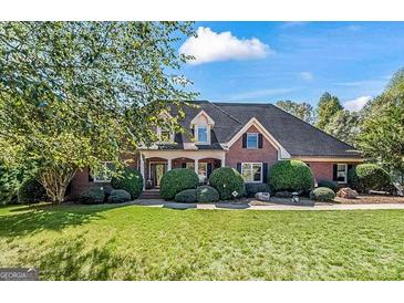 Brick house with a large front yard and mature trees at 168 Robson Trl, Mcdonough, GA 30252
