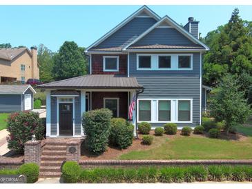Two-story craftsman home with gray siding, brick accents, and a charming front porch at 10 Plum Blossom Ln, Hampton, GA 30228