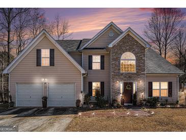 Two-story house with stone accents and a two-car garage at 106 Old Gettysburg Way, Dallas, GA 30157