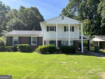 Brick ranch house with a two-car garage and well-maintained lawn at 2900 Eleanor Nw Ter, Atlanta, GA 30318