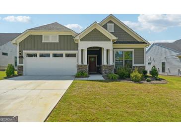 Craftsman style home with two-car garage and landscaped lawn at 361 Elkins Pl, Peachtree City, GA 30269