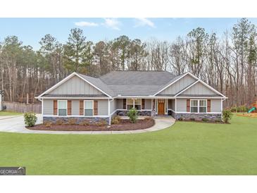 Gray house with stone accents and a landscaped lawn at 422 Northstar Dr, Villa Rica, GA 30180