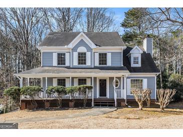 Two-story house with gray siding, white trim, and a covered porch at 2671 Eastmont Trl, Snellville, GA 30039