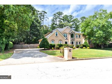 Two-story house with stone accents, landscaping, and driveway at 4335 Burgomeister Pl, Snellville, GA 30039