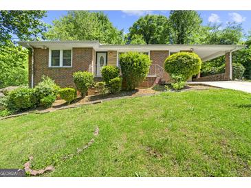 Brick ranch house with a landscaped yard at 241 Simon Ter, Atlanta, GA 30338