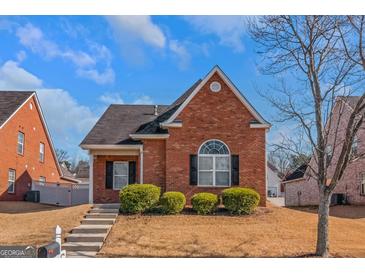 Brick ranch house with landscaping and a walkway at 625 Armitage Way, Stockbridge, GA 30281