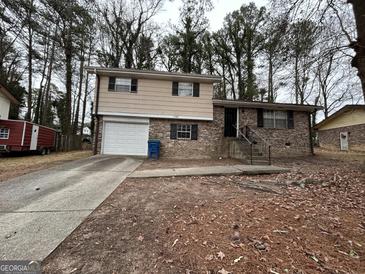 Ranch style home with attached garage and landscaping at 3780 Cedar Hurst Way, South Fulton, GA 30349