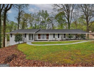 Ranch style home with gray exterior, landscaped lawn, and walkway at 1081 Veltre Sw Cir, Atlanta, GA 30311