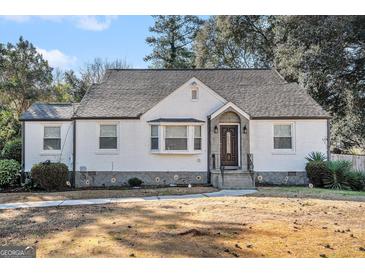 Charming white brick ranch house with a well-manicured lawn at 3199 Mcafee Rd, Decatur, GA 30032