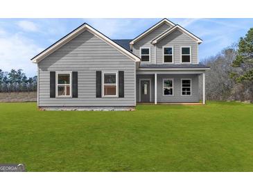 Charming two-story home with gray siding, black shutters and a well-manicured green lawn at 107 Oak Road, Locust Grove, GA 30248