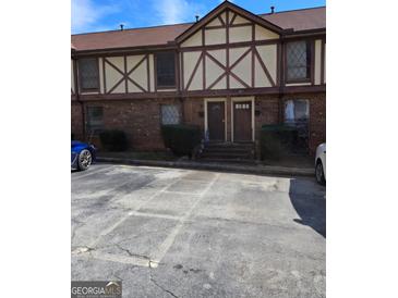 Brick townhouse exterior with two front doors and parking at 3209 Abbeywood Dr, Decatur, GA 30034