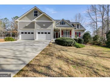 Two-story house with attached garage and landscaped yard at 2175 Ashton Dr, Villa Rica, GA 30180