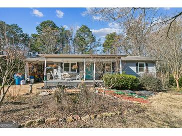 Charming ranch home with covered porch and landscaped yard at 315 Charlotte Blvd, Stockbridge, GA 30281