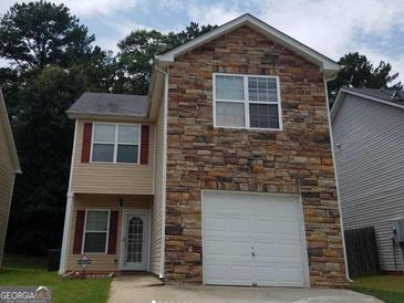 Two-story house with stone accents and a one-car garage at 7777 Newbury Dr, Jonesboro, GA 30236