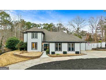Two-story house with a gray roof, white exterior, and landscaping at 103 Sandtrap Rdg, Peachtree City, GA 30269