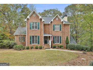 Charming brick two-story home featuring green shutters and a well-maintained front lawn at 337 Legacy Ln, Peachtree City, GA 30269