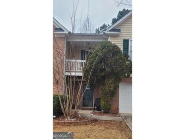 Charming two-story home with brick accents, front porch and manicured landscaping at 1923 Manhattan Pkwy, Decatur, GA 30035