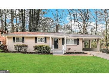 Charming single-story home with a manicured lawn, carport and mature trees at 2683 Terratim Ln, Decatur, GA 30034