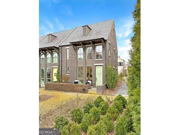 Charming brick townhome featuring a private courtyard and beautiful landscaping at 130 Glasgow Ln, Fayetteville, GA 30214
