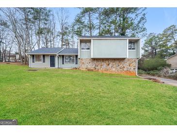 Charming home featuring a well-maintained lawn and unique architecture at 3417 Little Beth Ct, Decatur, GA 30034