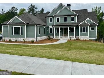 An inviting two-story home boasts meticulous landscaping and charming curb appeal at 130 Dockside Dr # 380, Fayetteville, GA 30215