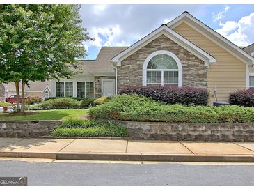 Charming home with stone accents, manicured landscaping, and a welcoming facade at 430 Rehobeth Way, Fayetteville, GA 30214