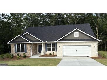 Charming single-story home featuring a stone facade, two-car garage, and well-maintained landscaping at 3382 Milan Ct # 3 Plapprox Sqft 3, Douglasville, GA 30135