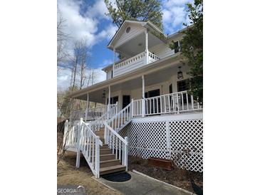 Charming exterior featuring a covered porch, two-story design and inviting staircase at 57 Kristina Ct, Acworth, GA 30101