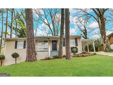 Charming single-story home with well-maintained lawn, covered parking and a welcoming front porch at 2634 Rockcliff Se Rd, Atlanta, GA 30316