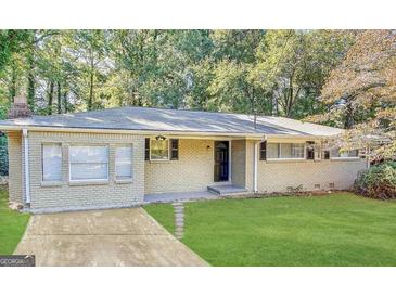 Charming brick home featuring a well-manicured lawn and welcoming front entrance, complete with lovely landscaping at 3647 Brookcrest Cir, Decatur, GA 30032