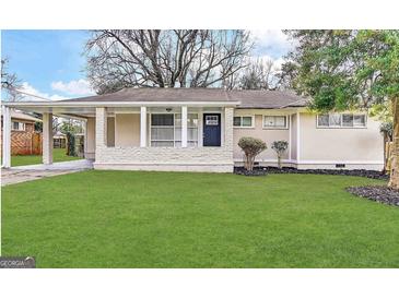 Charming single story home with a well-manicured green lawn and inviting front porch at 3415 Homera Pl, Decatur, GA 30032