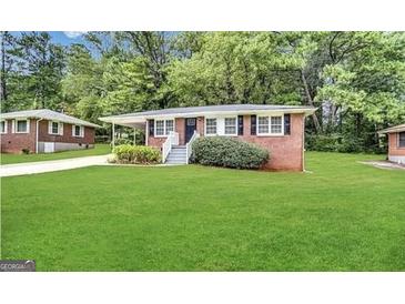 Charming single-story home featuring a well-maintained lawn and brick exterior at 648 Ozburn Nw Rd, Atlanta, GA 30318