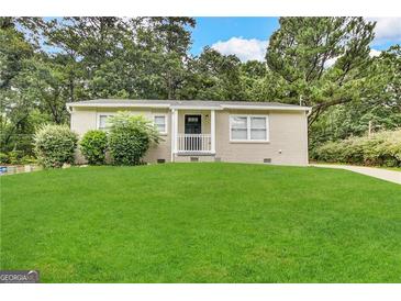 Charming brick home featuring a well-manicured lawn and inviting entrance at 3609 Croft Nw Pl, Atlanta, GA 30331