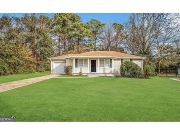 Charming brick home with a well-manicured lawn and inviting curb appeal at 1756 Lynn Ln, Decatur, GA 30032