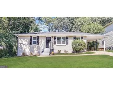Charming single-story home with a well-maintained lawn, a welcoming entrance, and a convenient carport at 2544 Brentwood Rd, Decatur, GA 30032