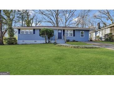 Charming one-story blue home featuring a well-maintained lawn, and a welcoming front porch at 2819 Gresham Rd, Atlanta, GA 30316