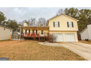 Charming two-story home featuring a covered front porch, two-car garage, and traditional design at 417 River Trace Dr, Villa Rica, GA 30180