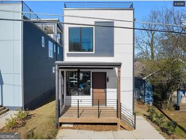 Modern home featuring a rooftop deck and a charming front porch with minimalist railings at 567 Middle Sw St, Atlanta, GA 30310