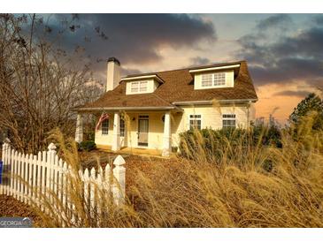 Charming two-story home with a welcoming front porch and manicured landscaping at 2683 Mariner Way, Villa Rica, GA 30180